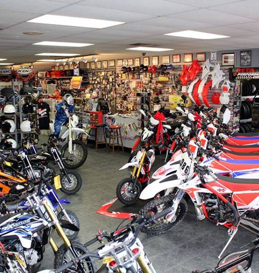 A room filled with lots of motorcycles and other items.