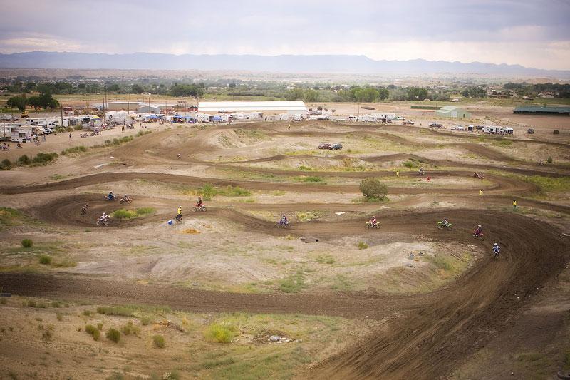 A dirt bike track with lots of people on it.