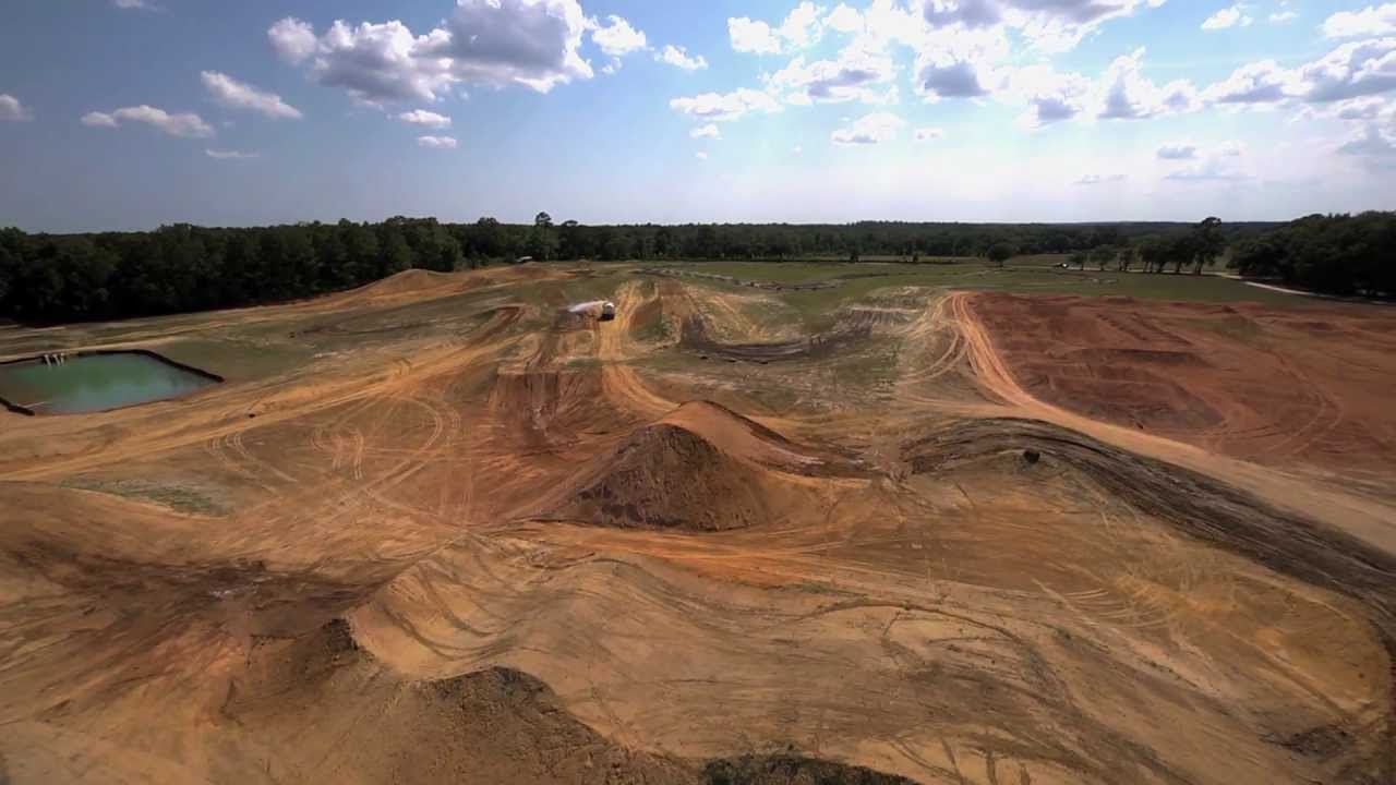 A dirt bike track with lots of hills and trees